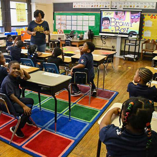 A teacher leads a classroom discussion with elementary students seated at their desks at Benjamin B. Comegys School.