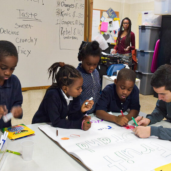 Elementary students collaborate on a poster during a hands-on classroom activity at Benjamin B. Comegys School.